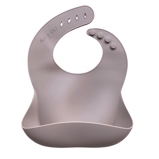 Babador de silicone com bolso cata migalha na cor nude.