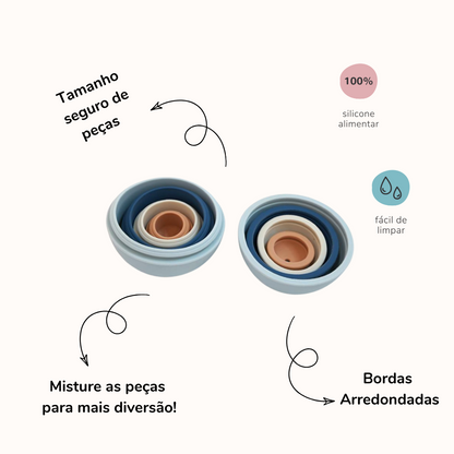 Bolas de silicone de cores variadas abertas ao meio, encaixadas, uma dentro da outra. A imagem contem textos com informações sobre o produto.